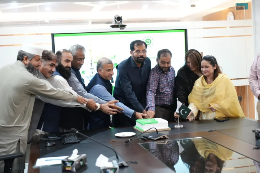 IBCC Executive Director Dr Ghulam Ali Mallah cutting Independence Day cake at IBCC Secretariat Islamabad