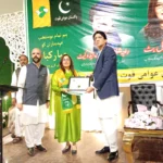 Aasma Ismail Butt receiving Pakistan Awami Quwwat party flag at oath-taking ceremony in Rawalpindi