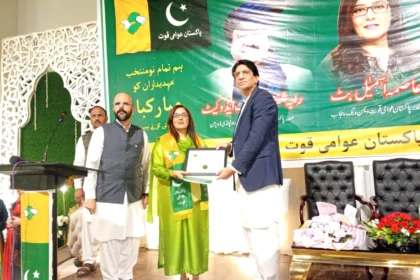 Aasma Ismail Butt receiving Pakistan Awami Quwwat party flag at oath-taking ceremony in Rawalpindi