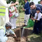 Participants planting a tree during EWCA Islamabad Chapter plantation drive at IIUI
