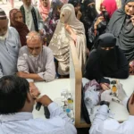 Health workers checking blood pressure at a screening camp in Pakistan