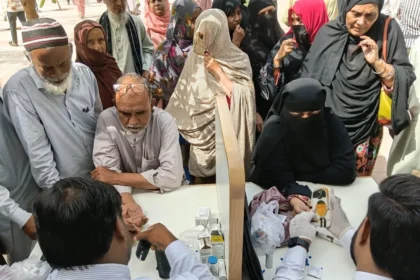Health workers checking blood pressure at a screening camp in Pakistan
