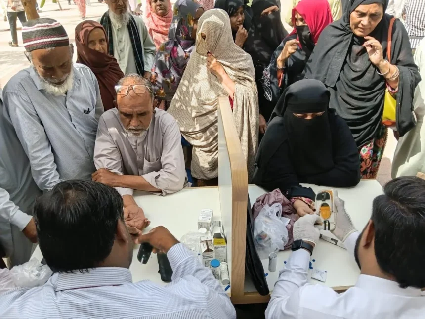 Health workers checking blood pressure at a screening camp in Pakistan