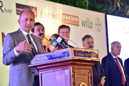 Federal Minister Dr Musadik Malik addressing a German Unity Day ceremony in Islamabad