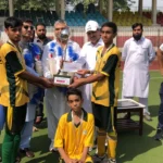 Chamkani team receiving Peshawar Inter-School Hockey Tournament trophy