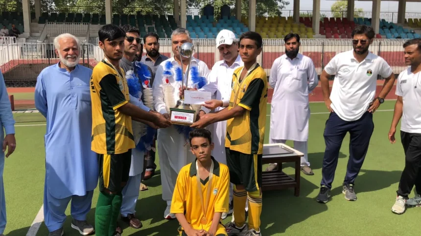 Chamkani team receiving Peshawar Inter-School Hockey Tournament trophy
